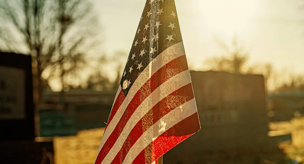 american flag in front of cemetery