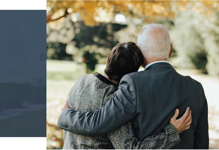 elderly couple embracing and facing away