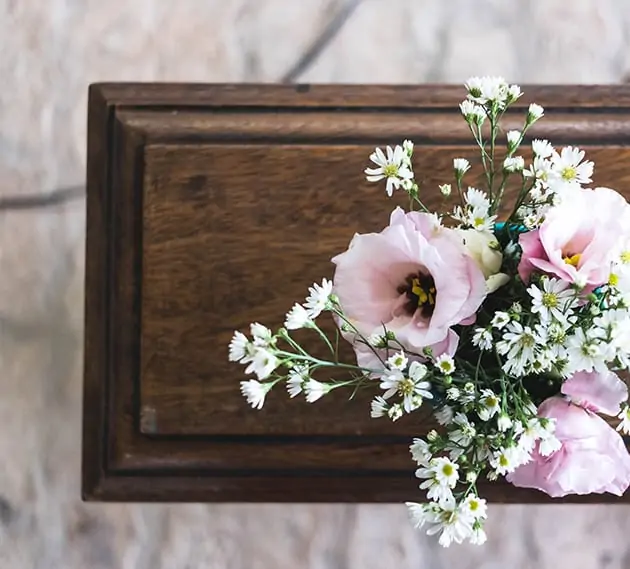 flower arrangement over a casket