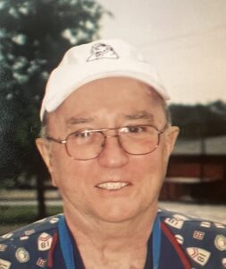 Elderly man in white cap and glasses smiling outdoors, emphasizing warmth and serenity at funeral service and cremation events.