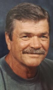 A man smiling at a funeral home in Alabama, cremation and burial services available.