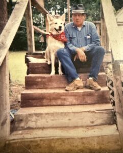 A man and his dog sit peacefully on steps, reflecting on funeral and cremation services in Alabama.
