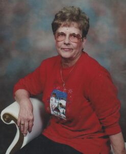 An older woman in glasses on a white chair, for Alabama funeral home or cremation services.