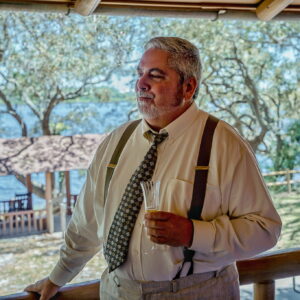 A man on a porch at an Alabama funeral home, reflecting on funerals and cremation services.