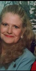 Smiling woman outdoors, representing Alabama funeral home and cremation services.