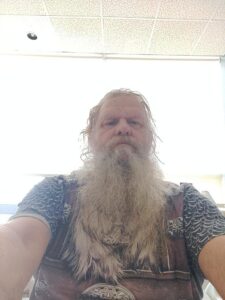 An elderly man with a long white beard, indoors, symbolizes Alabama funerals and cremation services.