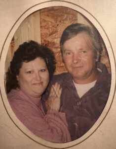 An Alabama couple smiles in a framed photo for funeral home, cremation, and obituary services.
